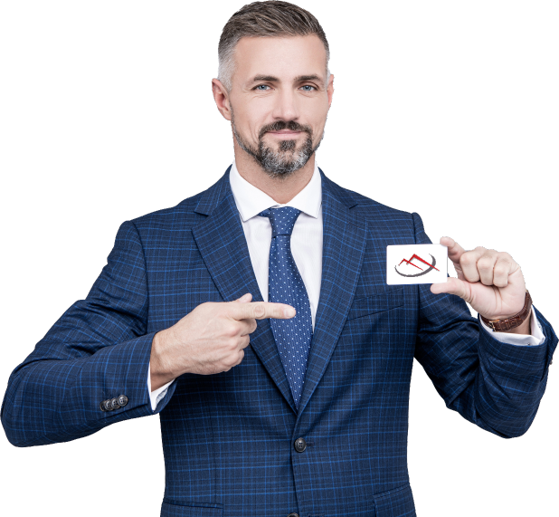 The image features a well-dressed man wearing a blue checkered suit, white shirt, and blue polka-dot tie. He has neatly groomed short gray hair and a beard. The man holds a small white card in his left hand and points to it with his right hand. The card showcases the MArvel Technologies Inc brand icon. He faces forward with a slight smile, presenting the card in a professional manner.