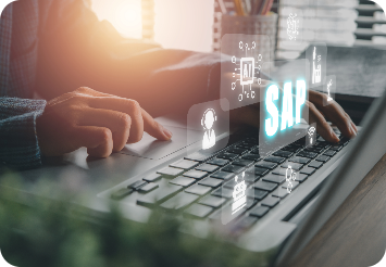 Person typing on a laptop with floating digital icons, including glowing blue 'SAP,' symbolizing technology and enterprise resource planning in a modern, productive setting